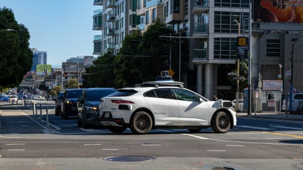 A white car is stopped at an intersection