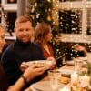 A joyful family gathering during Christmas with festive decorations and a delicious meal.