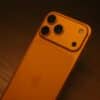 Orange smartphone with triple camera system