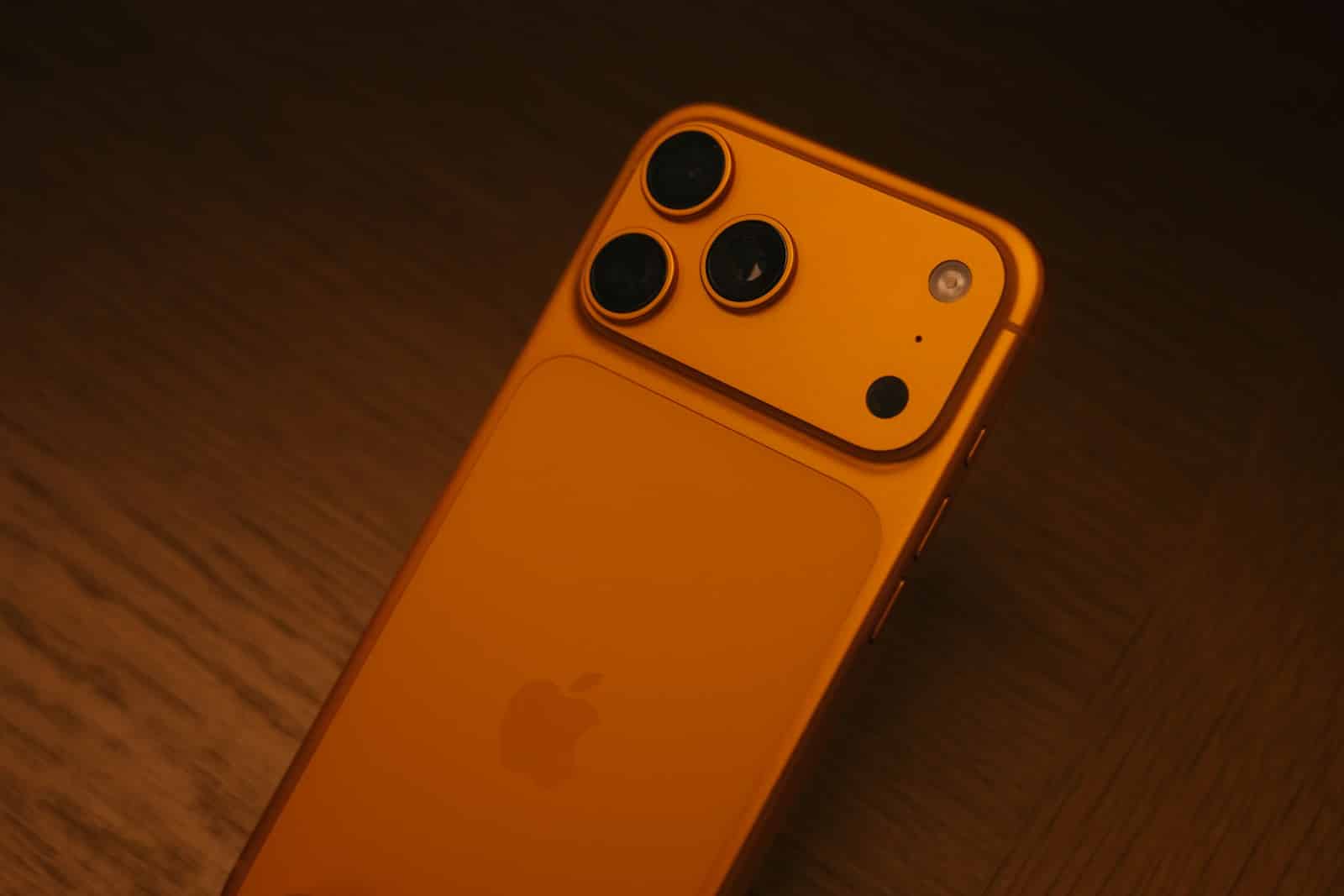 Orange smartphone with triple camera system
