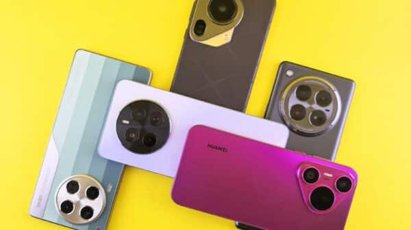 Several smartphones with unique camera designs arranged on yellow.