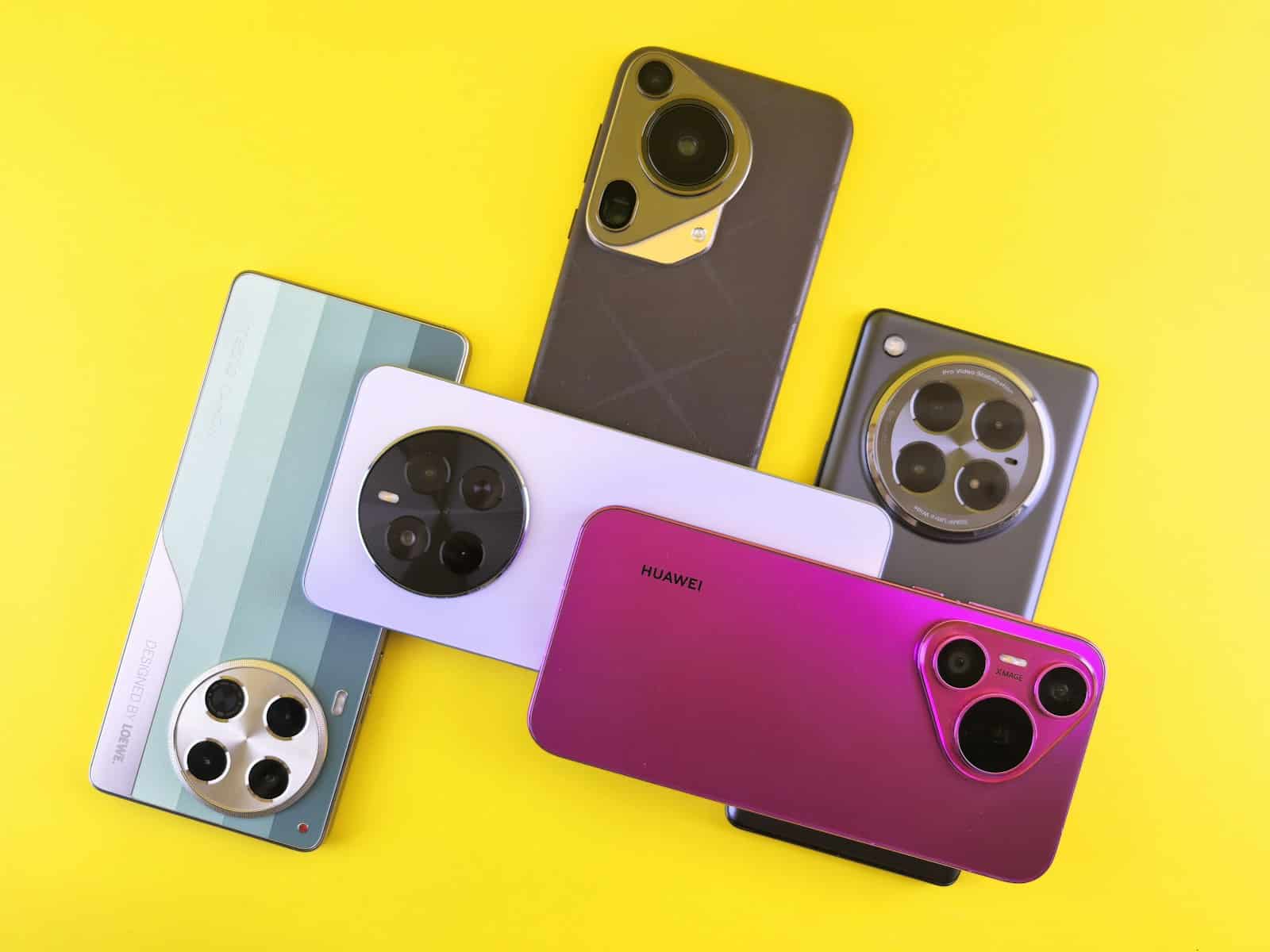 Several smartphones with unique camera designs arranged on yellow.
