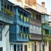 a row of multicolored buildings with balconies