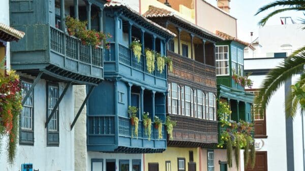 a row of multicolored buildings with balconies