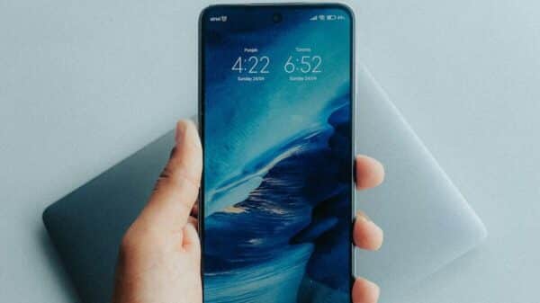 a hand holding a black smartphone