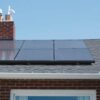 brown brick house with solar panels on roof