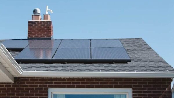 brown brick house with solar panels on roof