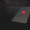 black laptop computer turned on with red light