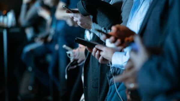 people using phone while standing