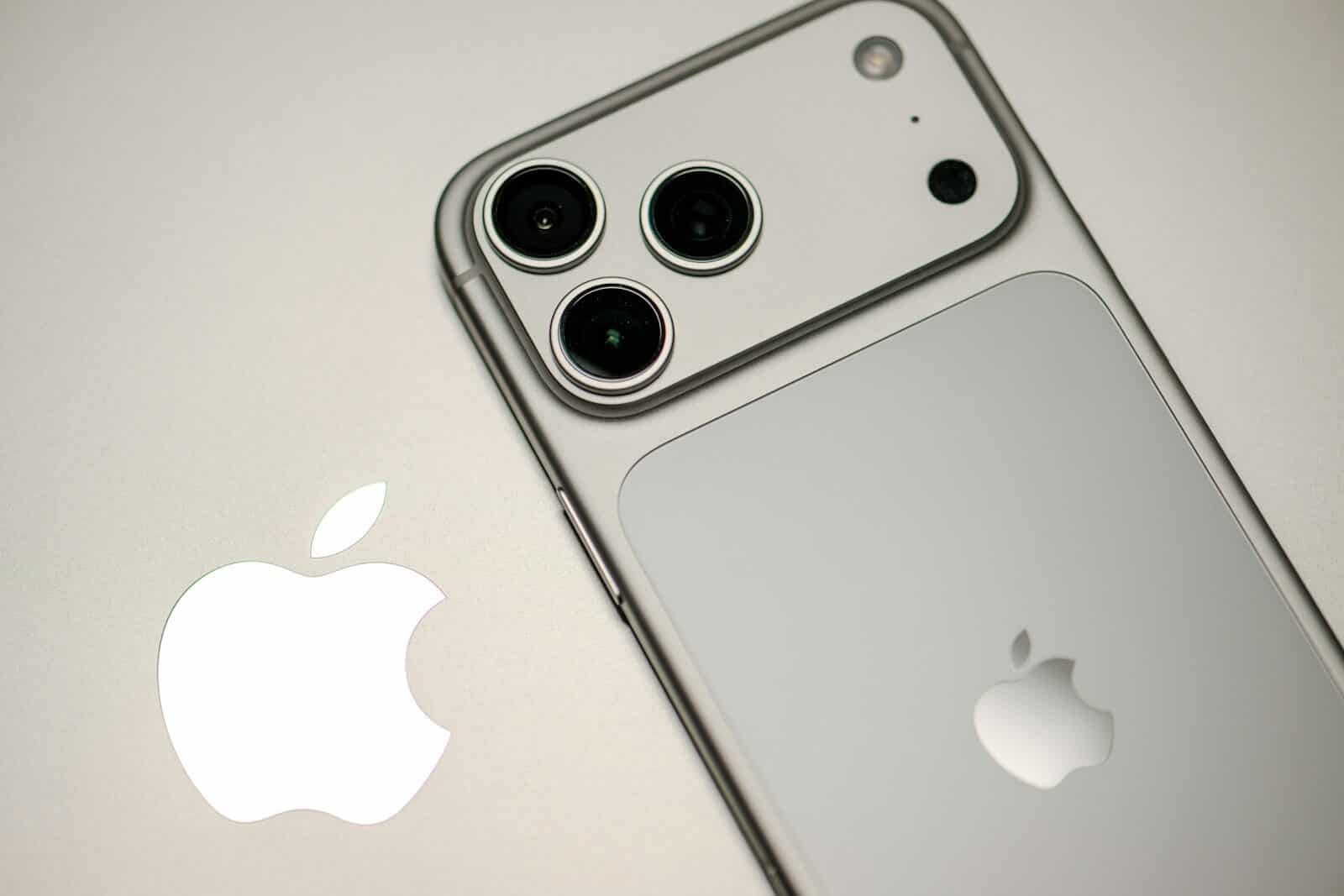 Close-up of a silver iPhone with apple logo.