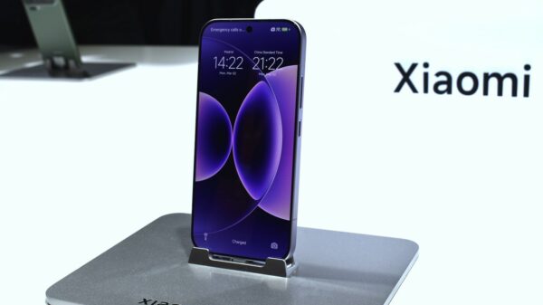 A purple xiaomi smartphone displayed on a stand.