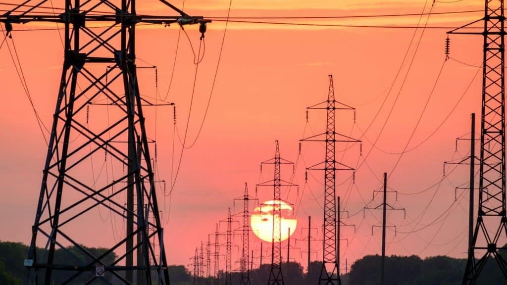 silhouette of electric post during sunset
