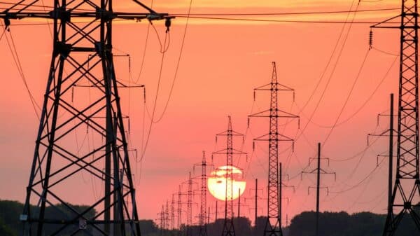 silhouette of electric post during sunset
