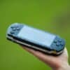 person holding blue sony ps 4 game console