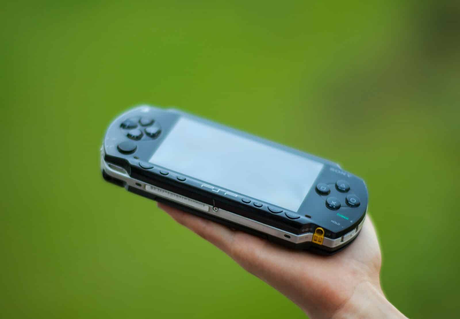 person holding blue sony ps 4 game console