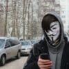 a person wearing a mask and holding a cell phone