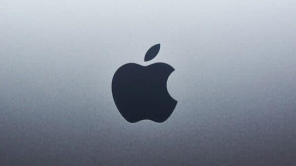 A dark apple logo centered on a smooth grey metallic surface
