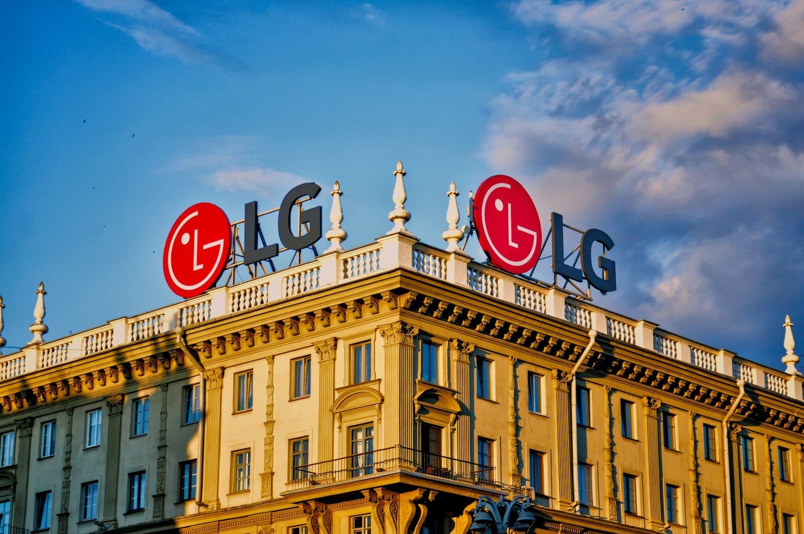 LG logos on a building roof under a blue sky