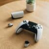 A ps5 controller and accessories rest on a table