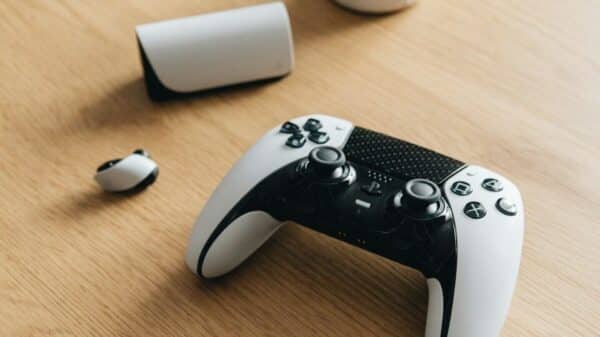 A ps5 controller and accessories rest on a table