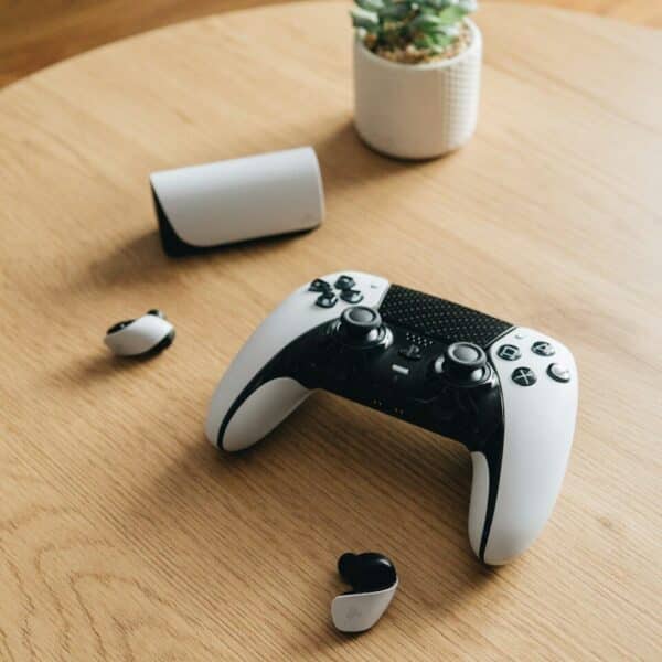 A ps5 controller and accessories rest on a table