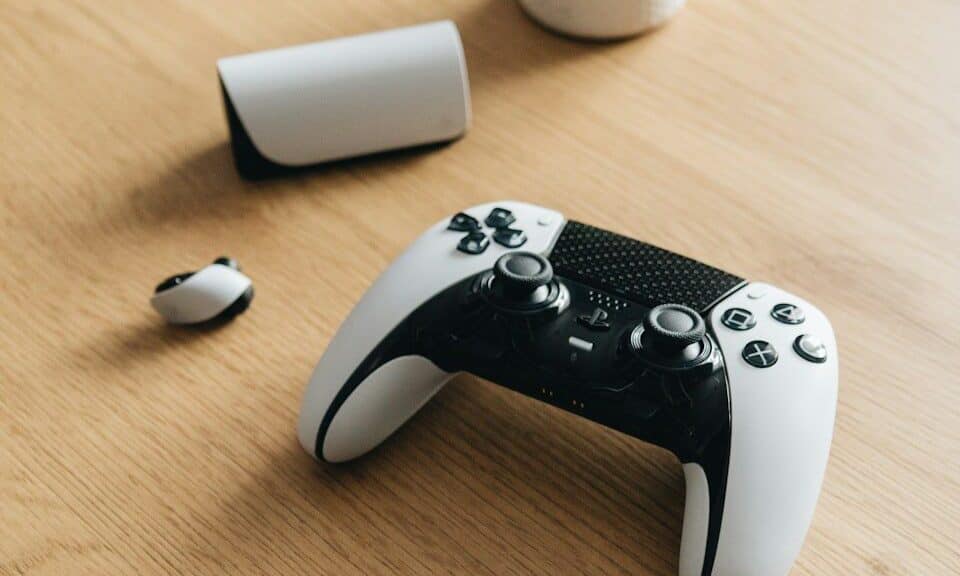 A ps5 controller and accessories rest on a table