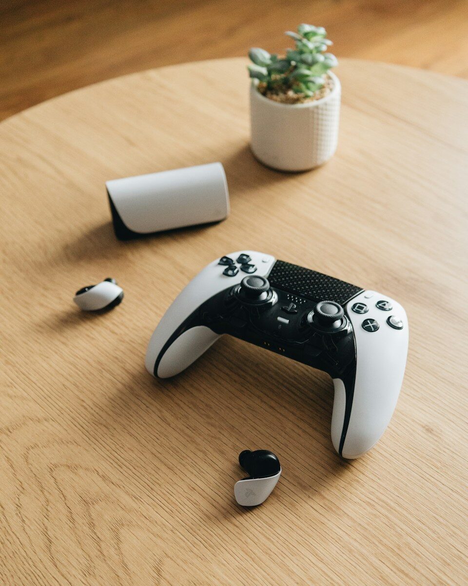 A ps5 controller and accessories rest on a table