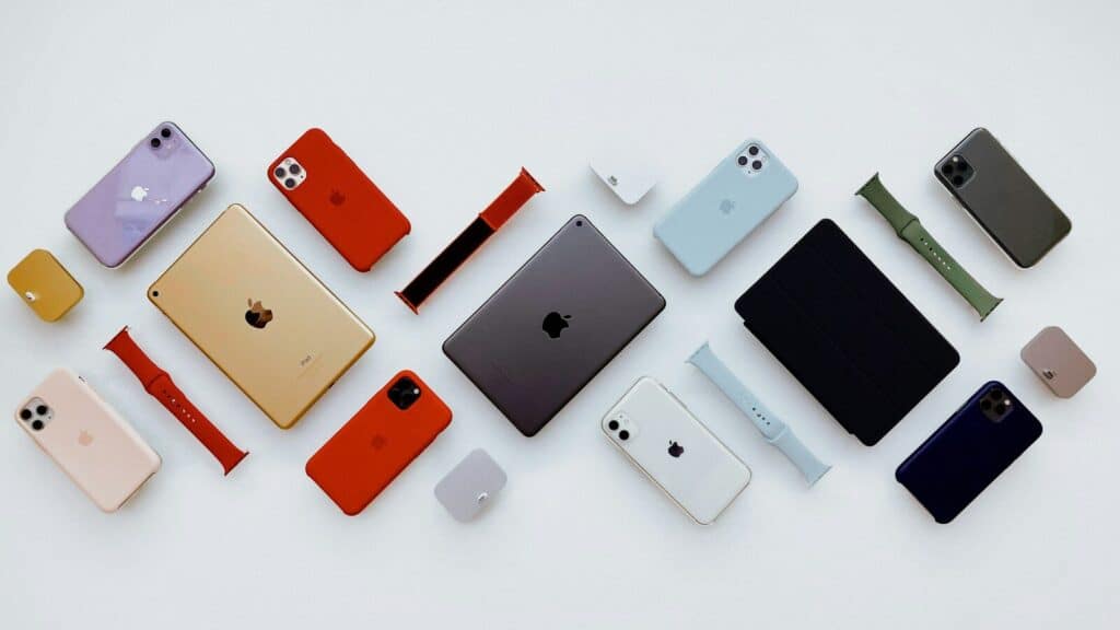a group of different colored cell phones sitting next to each other